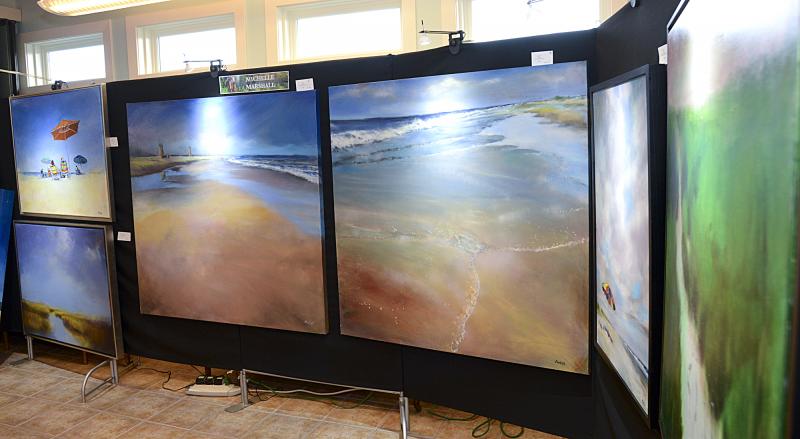 Michelle Marshall offers a wall of beach scenes for purchase.